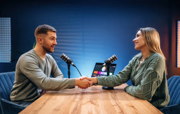 istock Making handshake. Radio hosts recording podcast 2189018513