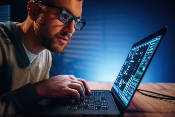istock Focused on job. Male programmer is working indoors by a laptop 2189018895