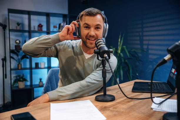 istock Morning radio. Man with microphone in the studio, conception of podcast 2189019300
