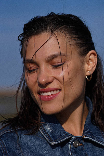 istock Close up of young woman face with beautiful smile 2189019708