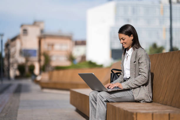 istock Young black businesswoman using laptop outdoors after work 2189019921