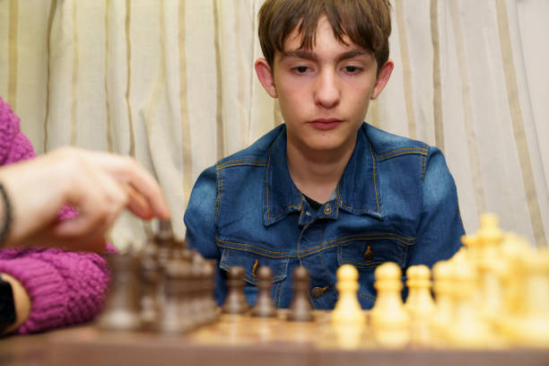 istock Teenager concentrating while playing chess in a camper van 2189020163