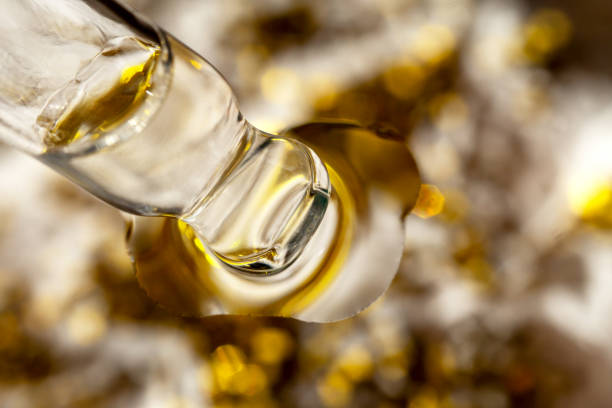 istock A drop of cosmetic aromatic oil drips from the pipette. Front view. 2189021102