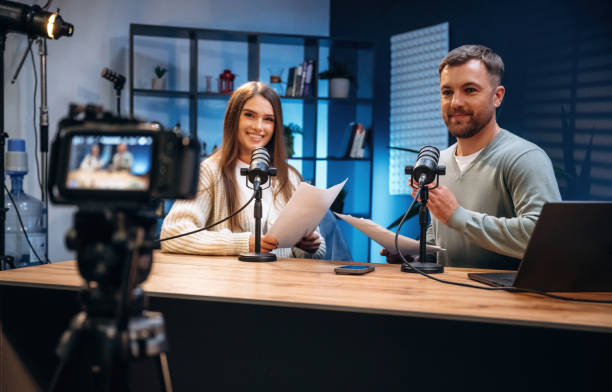 istock Tow people, together. Radio hosts recording podcast 2189021497