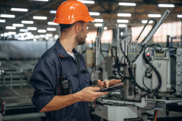 istock Machinery conception, operator is with tablet. Man is working in the modern factory 2189022540