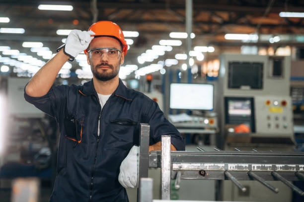 istock In the orange colored hardhat. Man is working in the modern factory 2189022729