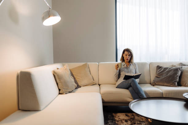 istock Senior woman reading book at home 2189022831