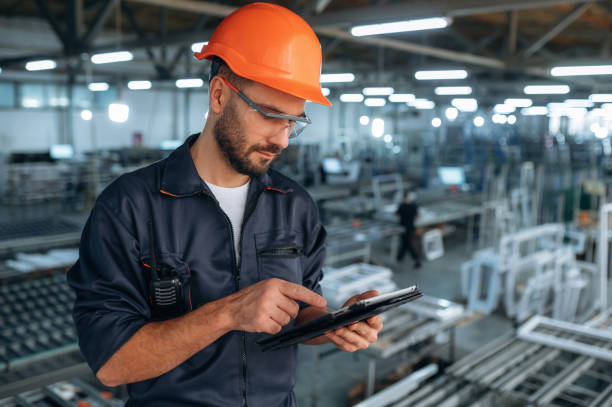 istock Black colored tablet in hands. Man is working in the modern factory 2189022961