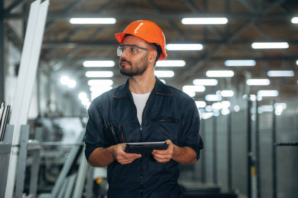 istock Black colored tablet in hands. Man is working in the modern factory 2189022963
