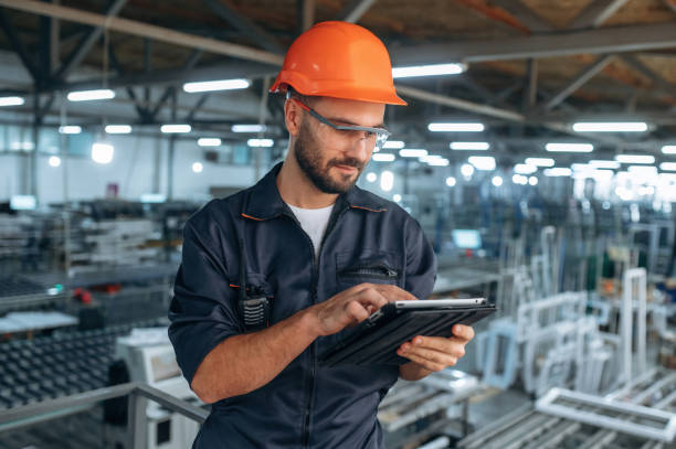 istock Contractor is with digital tablet. Man is working in the modern factory 2189023012