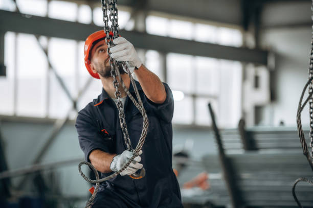 istock Using the cables that are hanging up. Man is working in the modern factory 2189023938