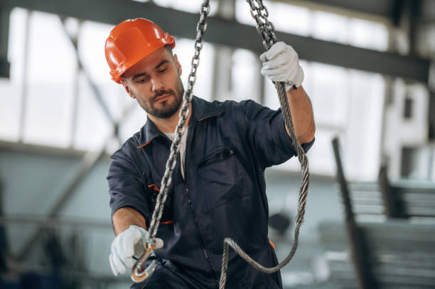 istock Using the cables that are hanging up. Man is working in the modern factory 2189023940