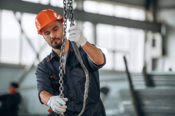 istock Using the cables that are hanging up. Man is working in the modern factory 2189023946