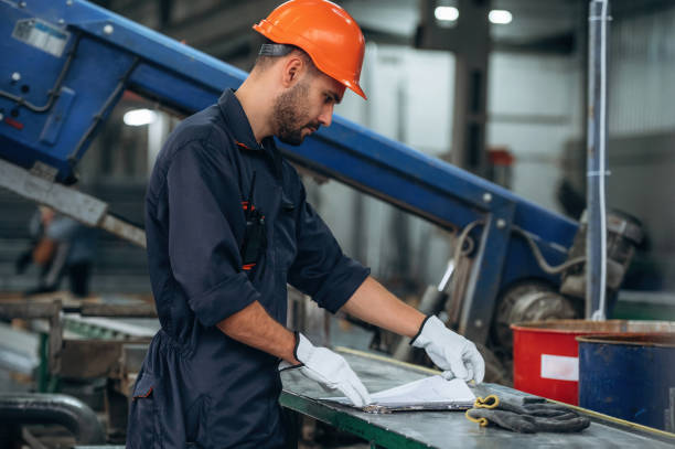 istock By the machine, operator is taking notes. Man is working in the modern factory 2189023992