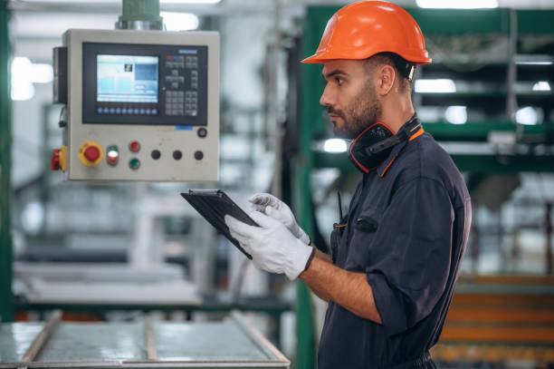 istock Operating the machine. Man is working in the modern factory 2189024097