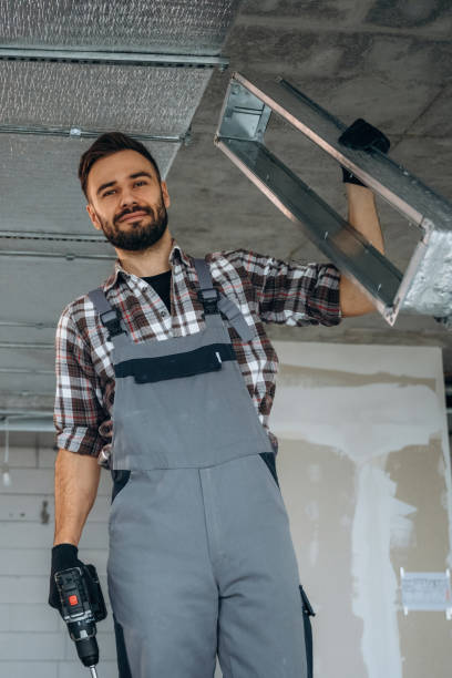 istock Installing the ceiling. A man is renovating an unfinished room 2189025227