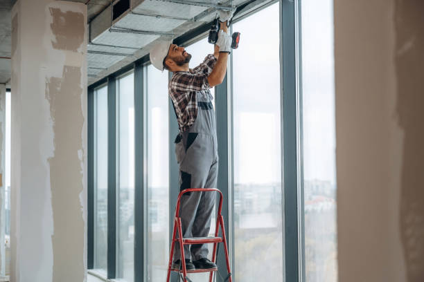istock Near the windows. A man is renovating an unfinished room 2189025421