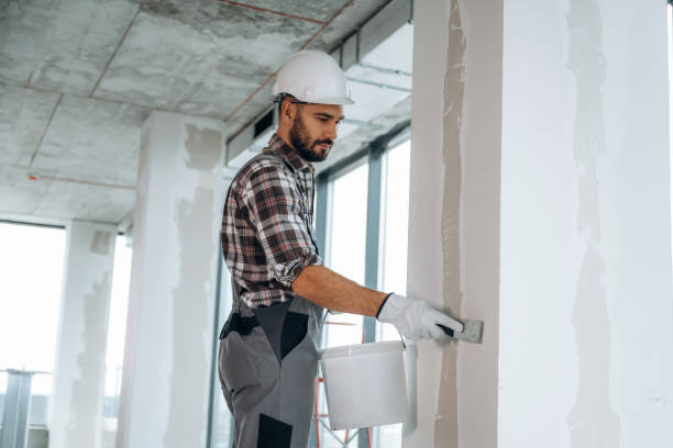 istock Puttying the wall. A man is renovating an unfinished room 2189025687