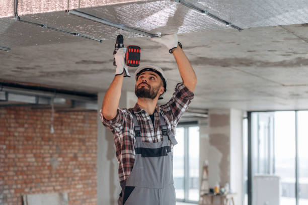 istock Hands are up, ceiling work. A man is renovating an unfinished room 2189025697