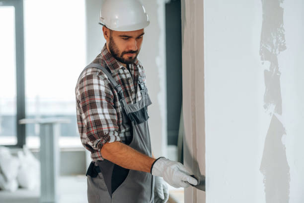 istock Puttying the wall. A man is renovating an unfinished room 2189025747