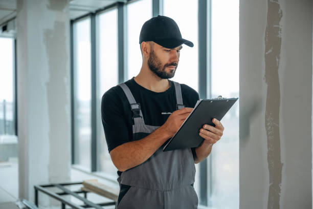 istock Notepad is in hands. A man is renovating an unfinished room 2189026744