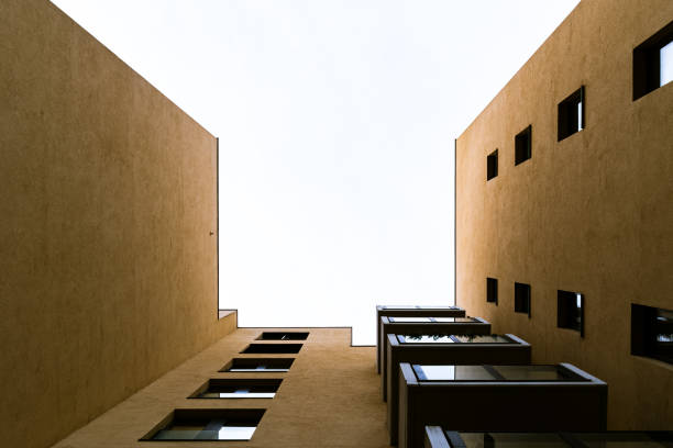 Modern Building Courtyard with Minimalist Design and Symmetrical Windows Looking Upward