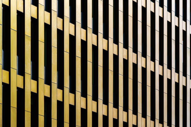 Abstract Golden Facade with Vertical Panels and Geometric Repetitions in Modern Architecture