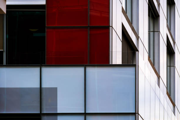 istock Modern Building Facade with Red and White Panels and Reflective Glass Windows 2189027649