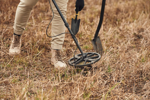 istock Sensitive sensor, searching. Man is with metal detector in the field 2189028195