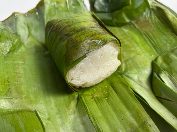 istock Lemper, is a snack made from glutinous rice, filled with chicken, meat or fish floss, wrapped in banana leaf 2189028350