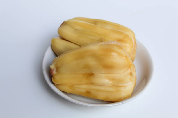 Yellow Jackfruit flesh from Artocarpus heterophyllus, on small white plate, isolated on white background