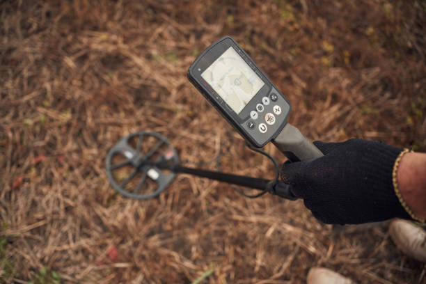 istock Sensitive sensor, searching. Man is with metal detector in the field 2189028579