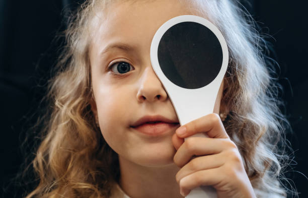 istock Session of testing the sight sharpness. Little girl is checking vision in the ophthalmologist cabinet 2189031161