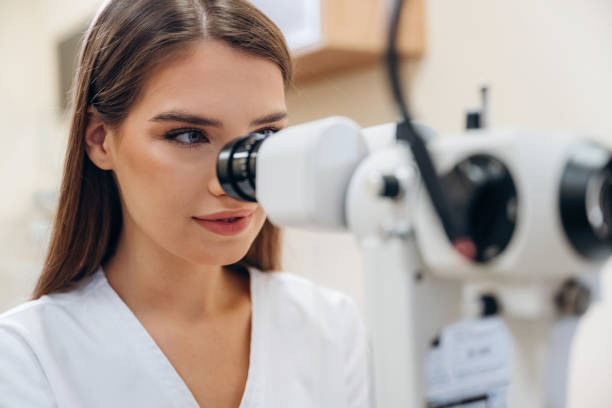 istock Digital optical device. Young female ophthalmologist is in the cabinet 2189031802