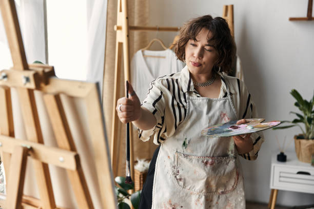 istock Creative woman expressing herself through painting in a stylish home setting 2189031821