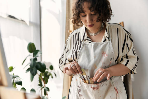 istock Creative woman organizing her art supplies in a modern home studio during the day 2189031846