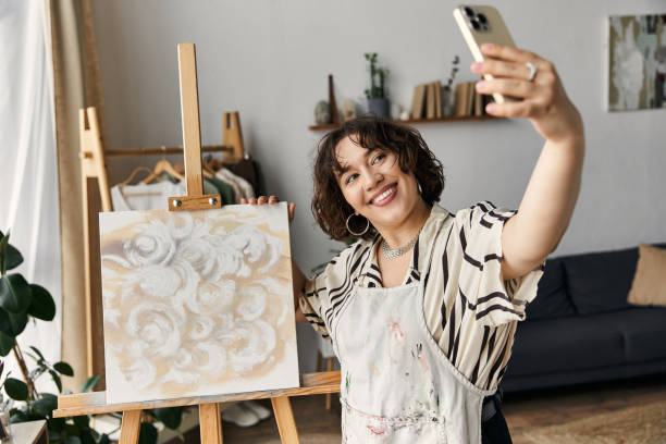 istock Creative young woman capturing a moment at home with her artwork in a modern apartment 2189031982