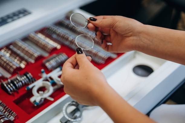 istock Ophthalmologist is picking different lenses that are in the kit 2189032067