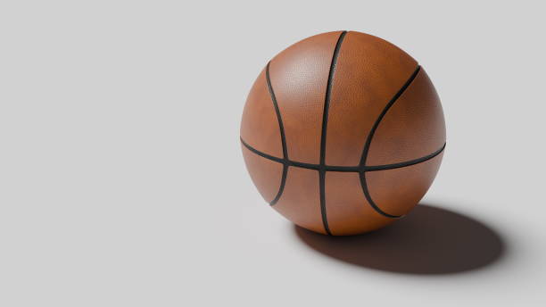 istock basketball sits on a smooth surface, casting a soft shadow. Its detailed texture and design are prominently displayed, highlighting the brown leather and black lines typical of this sport 2189032277