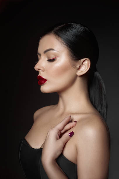 istock woman displays her elegant style with bold red lips and striking eyeliner 2189032330