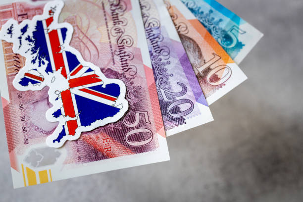 istock British money and national emblem, Gray background, copy space, flat lay, Financial background, Great Britain pounds  banknotes, close up 2189032649