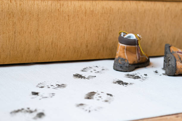 istock Dirty boots leave muddy footprints on clean floor 2189033959