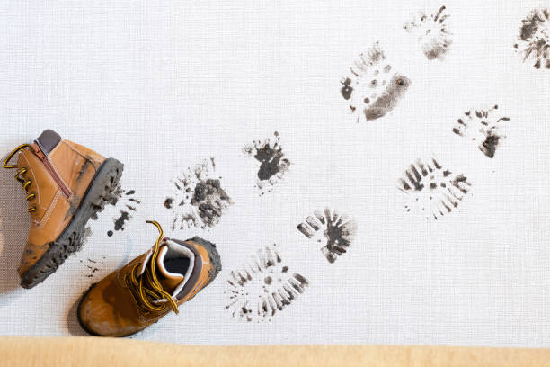 istock Dirty boots leave muddy footprints on clean floor 2189033962