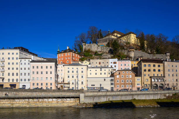 Panoramic view of the Kapuzinerberg with the colorful buildings along the Salzach river in Salzburg.