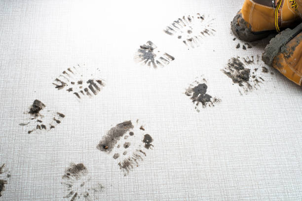 istock Dirty boots leave muddy footprints on carpet 2189034069