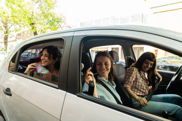 istock Friends putting seat belt inside car 2189035711