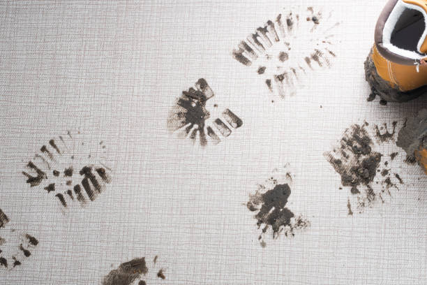 istock Dirty boots leave muddy footprints on a carpet 2189035735