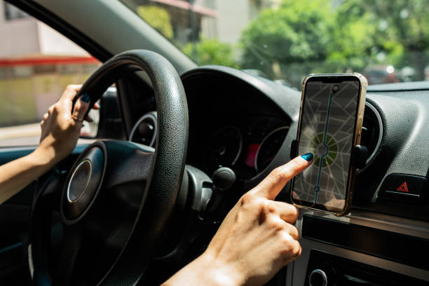 istock Close-up of a woman driving and using mobile app inside car 2189035838