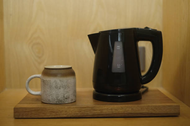 istock Electric Kettle and Ceramic Mug on a Wooden Tray 2189036465