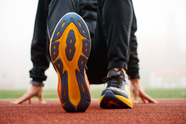 istock Athlete wearing modern running shoes walking on stadium track 2189037145